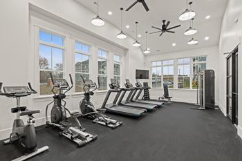 the gym with treadmills and ellipticals and windows at Hadley Place Apartments, Pennsylvania, 17025
